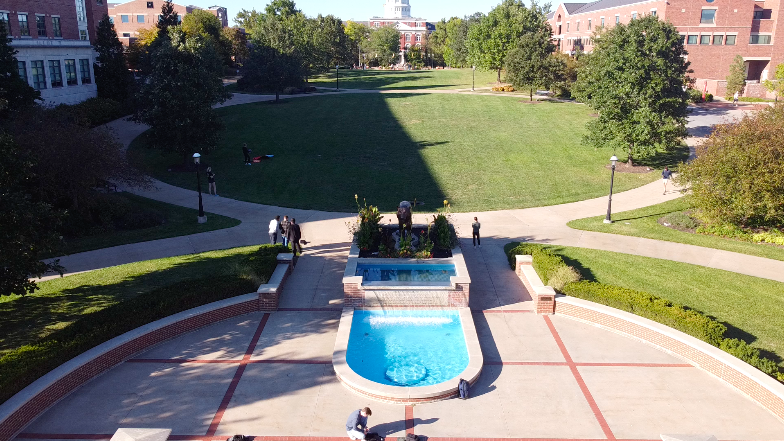 At the end of Carnahan Quad, this photo shows the blue fountain in front of a metal tiger statue.